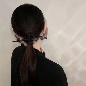 Black wooden women's hair style hairpin on the back of the head